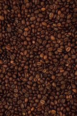 Brown roasted coffee beans on dark background