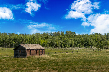 Fototapeta na wymiar Rustic buildings in a farmers field Allingham Alberta Canada