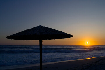 An umbrella silhouette during sunset in Vrahos beach.