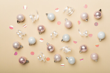 Christmas balls on color background, top view