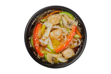 Instant soup, noodles wok, with vegetables, herbs and sesame. In a black round plate. On a white background.