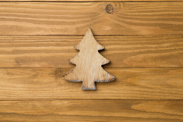 Wooden Christmas tree on wooden background, top view