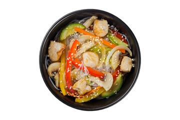 Noodles wok, with vegetables, herbs and sesame. In a black round plate. On a white background.