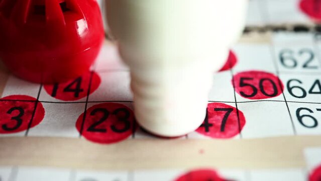 Playing bingo, marking numbers with red marker. High quality 4k footage