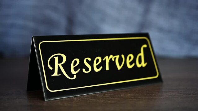 Putting reserved sign on a restaurant table. High quality 4k footage