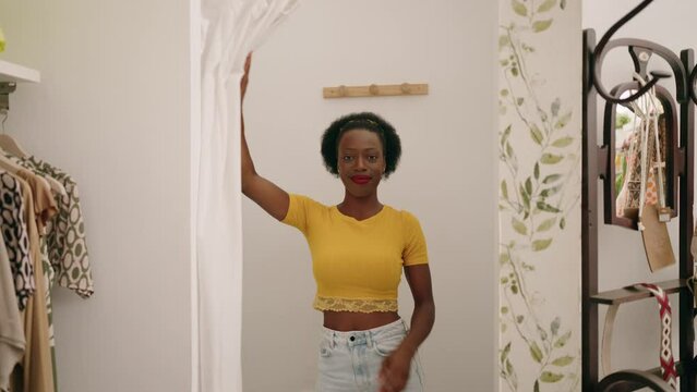 African american woman customer wearing t shirt at clothing store
