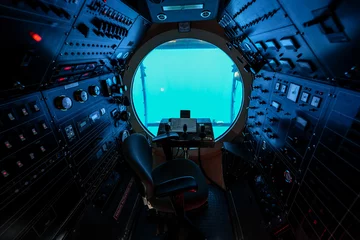 Fotobehang Cockpit of a submarine offering underwater cruises from Waikiki Beach in Honolulu, Hawaii - Round porthole with a steering wheel and dozens of switches used to make a submersible ship dive © Alexandre ROSA