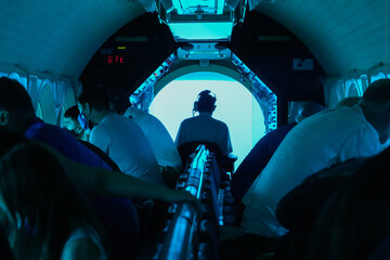 Captain steering a submarine full of tourists during a dive in Mamala Bay near Waikiki Beach in...