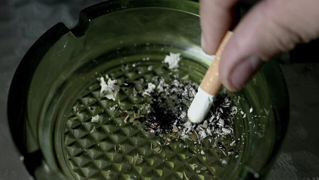 Cigarette is being put out in the ashtray. High quality 4k footage