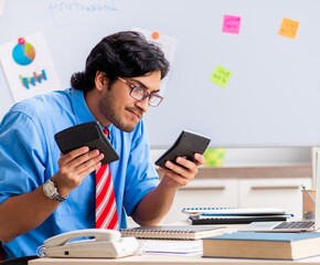 Young male financial manager working in the office