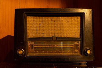 old 1950s retro Vintage fashioned radio with volume tuner knob and stereo receiver or speaker and dial button isolated in the stand.