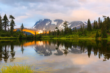 Mount Shuksan at sunset with reflection view from Picture Lake, Deming Washington. Picture Lake is the centerpiece of a strikingly beautiful landscape in the Heather Meadows area
