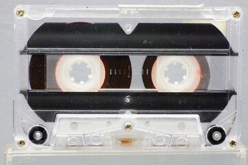 Cassette tape - close-up of the whole frame, black background.