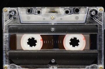 Cassette tape - close-up of the whole frame, black background. - obrazy, fototapety, plakaty