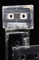 Cassette tapes - unprinted, has black background, stacked vertically and horizontally.