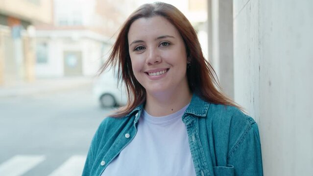 Young beautiful plus size woman smiling confident standing at street