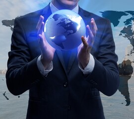Businessman holding globe in global business concept