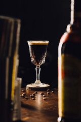 espresso martini cocktail in a fancy elegant glass with coffee beans in a table