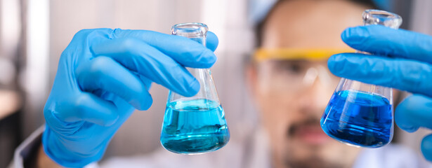 blue chemical liquid experiment in scientific glassware equipment in science medicine laboratory, chemistry or biology research discovery by using glass of test tube or beaker and flask - obrazy, fototapety, plakaty