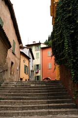 Photo of ancient steps leading to courtyard behind traditional Italian homes in the medieval city of Brisighella, Emilia-Romagna, Italy