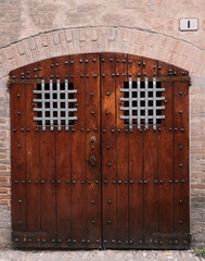 Beautiful old wooden doors with metal grilled windows, Brisighella, Emilia-Romagna, Italy