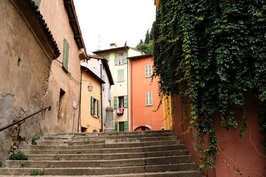 Photo of ancient steps leading to courtyard behind traditional Italian homes in the medieval city of Brisighella, Emilia-Romagna, Italy