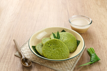 Serabi or Surabi,  Indonesian pancake made of flour, rice flour and coconut milk. Served with palm sugar sauce. Sweet and savory. 
