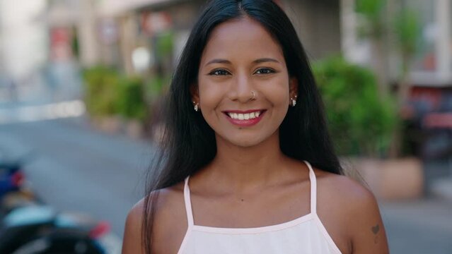 Young beautiful woman smiling confident standing at street