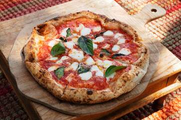 Margherita pizza on wooden cutting board 