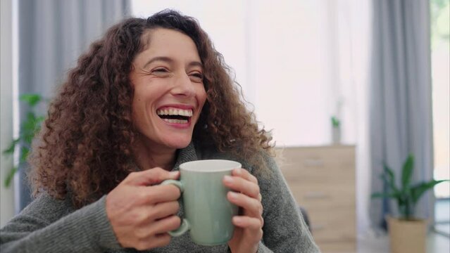 Relax, smile and woman drinking coffee on a sofa while sitting in the living room at home. Happy, laugh and lady from colombia relaxing and enjoying a cup of tea on the couch in her modern house.