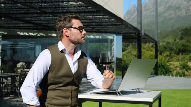 confident man in shirt with glass of wine and computer on vacation. Men Calling By Video Chat His Friend And Drinking Wine With Him. Online Date, Meeting With Friend. Social Distance and Isolation