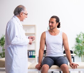 Fototapeta premium Young male patient visiting experienced doctor