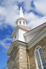 Fototapeta premium low angle view of ancient church tower against blue sky
