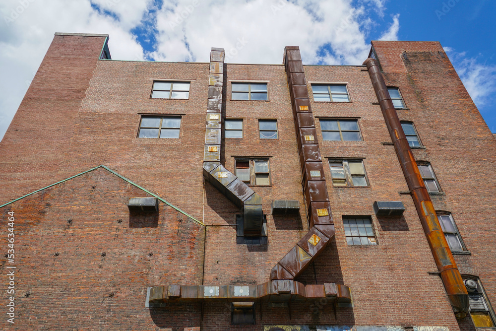 Poster low angle view of old brick building with rustic pipe