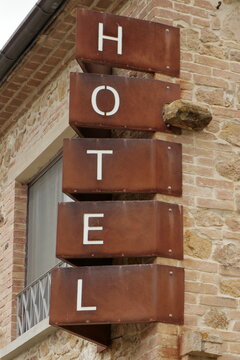 Rustic boutique hotel hanging from side of building