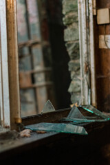 Fototapeta na wymiar Reflection in Broken Glass in Abandoned Dirty House