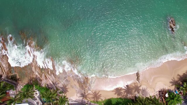 Aerial view Beautiful waves flowing on seashore rocks in a dark sea, ocean sea surface, Amazing sea waves crashing on rocks seascape Aerial view drone 4k High quality of ocean with stone rock cliff