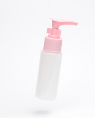 Bottle cream or liquid soap with dispenser levitating on white background