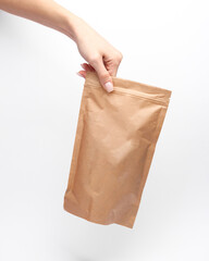 Craft product packaging with white label mockup in female hand on white background