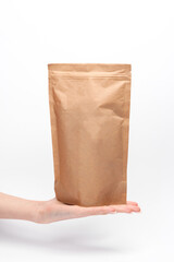 Craft product packaging with white label mockup in female palm on white background