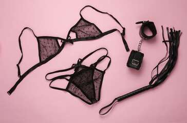 Sex games. Different toys from sex shop on pink background. Top view