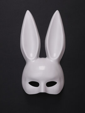 White rabbit mask with long ears from a sex shop on black background