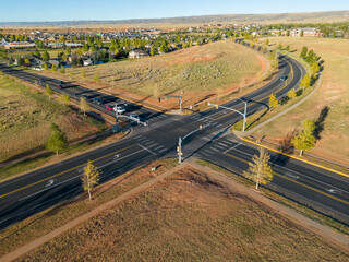 Car traffic intersection with stop lights roads in rural Fall Wyoming from 4k Aerial drone dji mini 3 pro