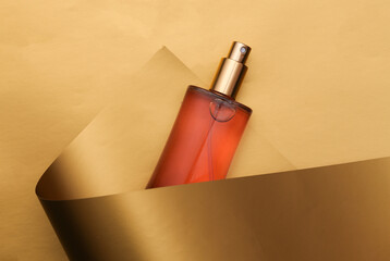 Perfume bottle on luxurious golden background