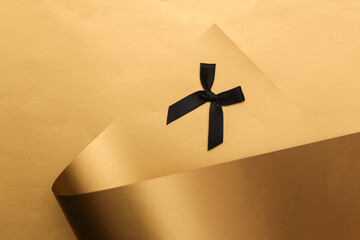 Black ribbon on a luxurious golden background