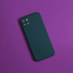 Modern smartphone with a quad camera and a fingerprint sensor on the back, purple background