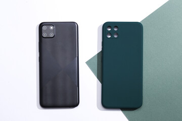 Smartphone with protective cover on paper background. Top view