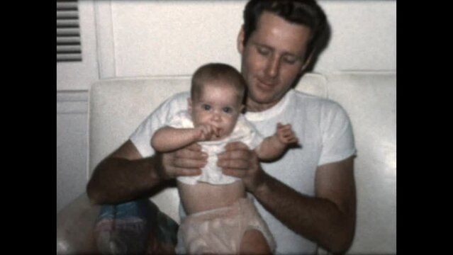Father and Daughter 1965 - A father sits with his daughter on a sofa in 1965. 
