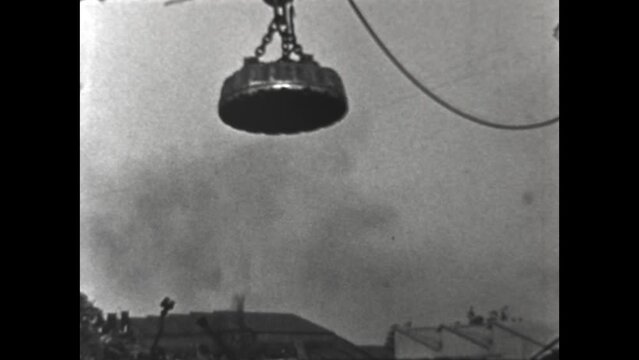 Moving Scrap Metal 1938 - A crane moves scrap metal in a Los Angeles, California scrapyard in 1938. 
