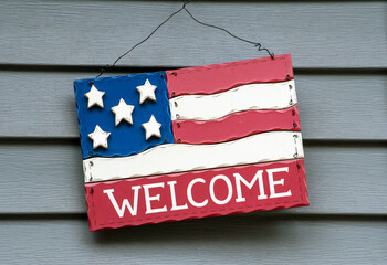  decorative wooden welcome sign on a home, looking like n American flag